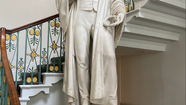 Micheal Faraday as a marble sculpture with a black mask on